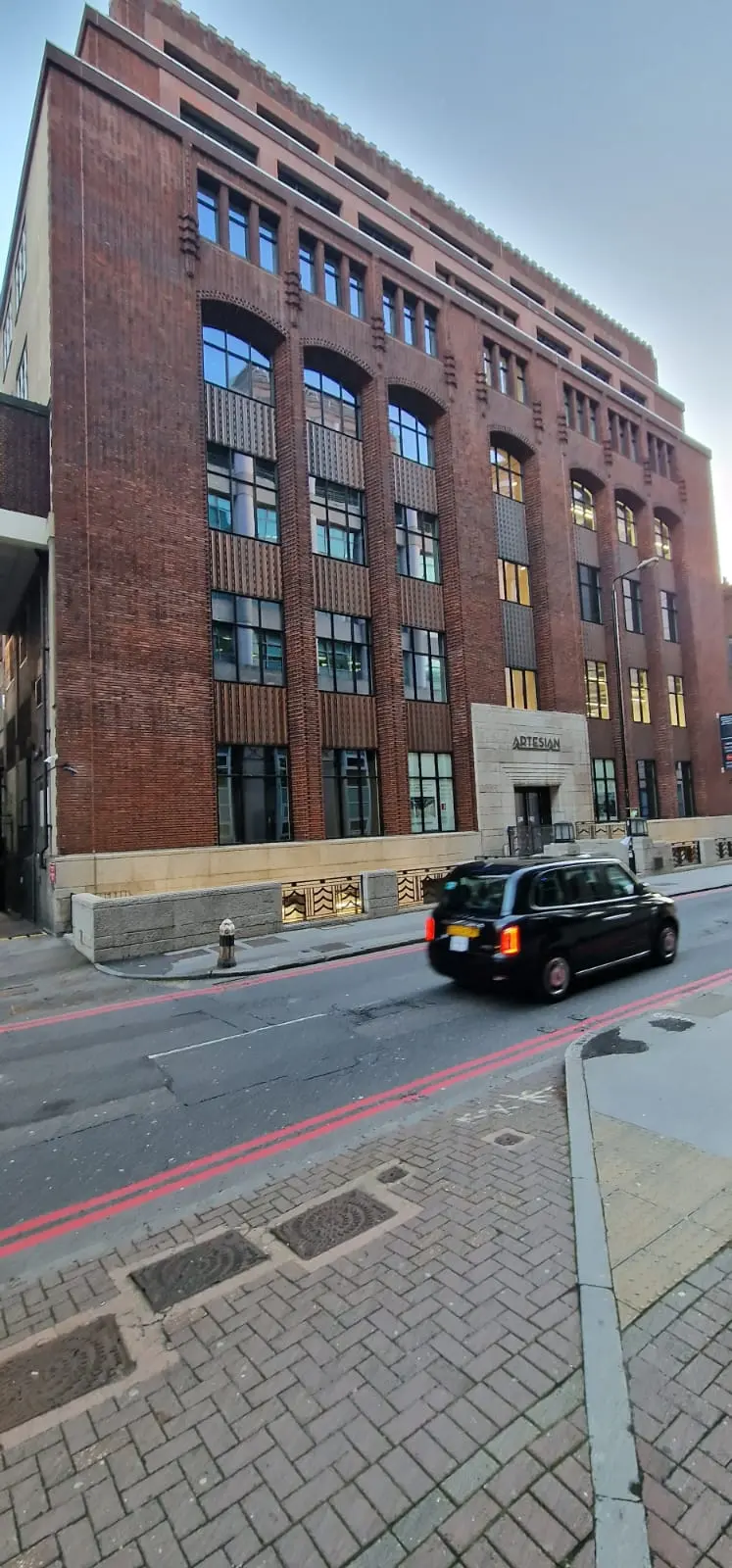 Prescot Street office building in Whitechapel: brick façade with tall aluminium-framed glazed bays